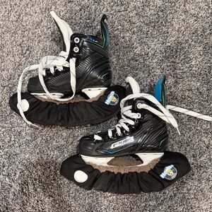 Bauer XLP Youth Black Hockey Skates with Blue and Green Accents